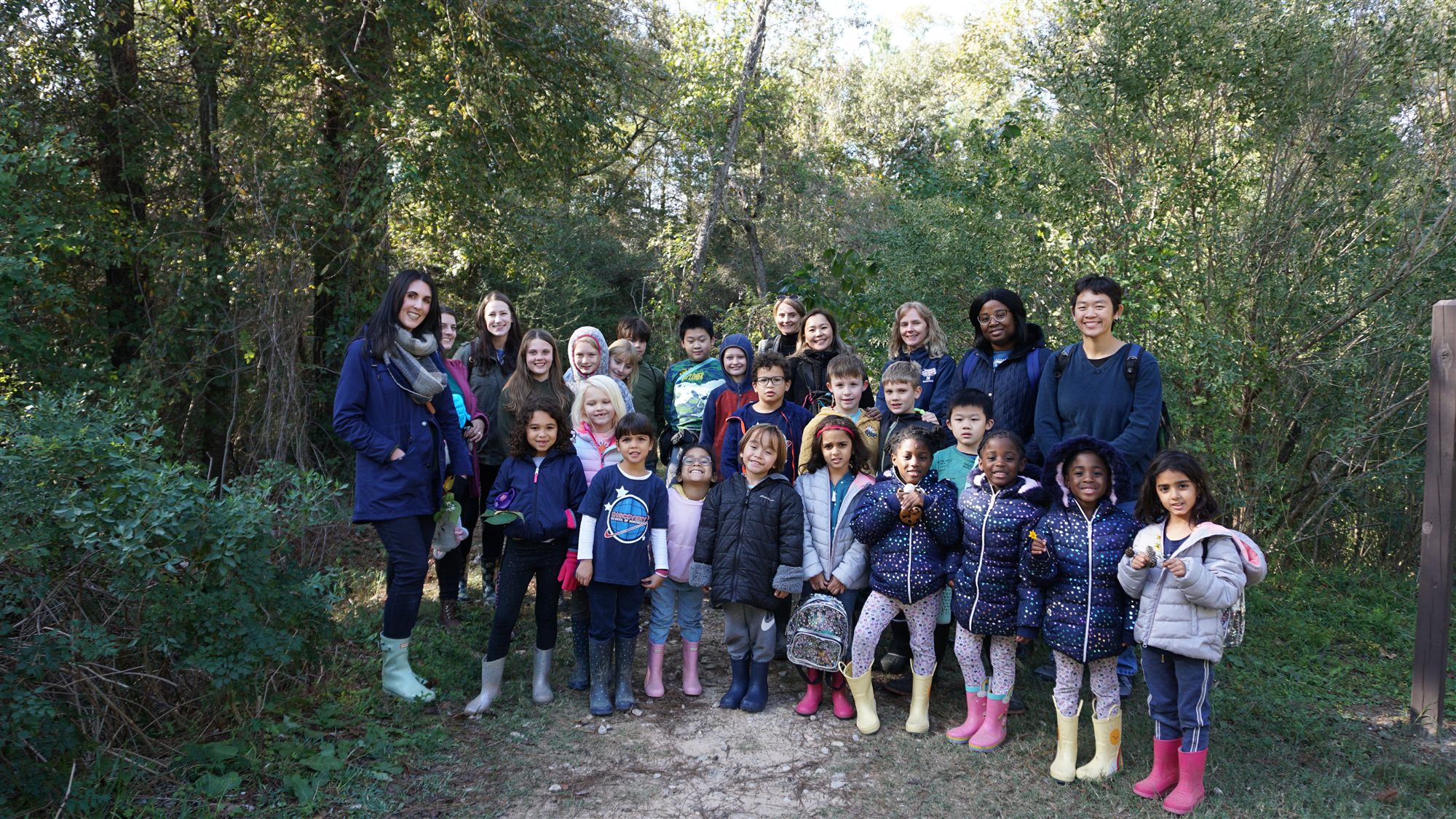 Students and educators gathered on a preserve trail